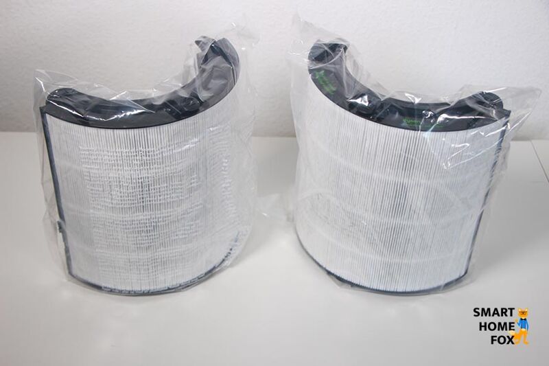 Die Filtereinheiten vom Dyson Purifier Cool sind in Schutzfolie verpackt und stehen auf einem Tisch.